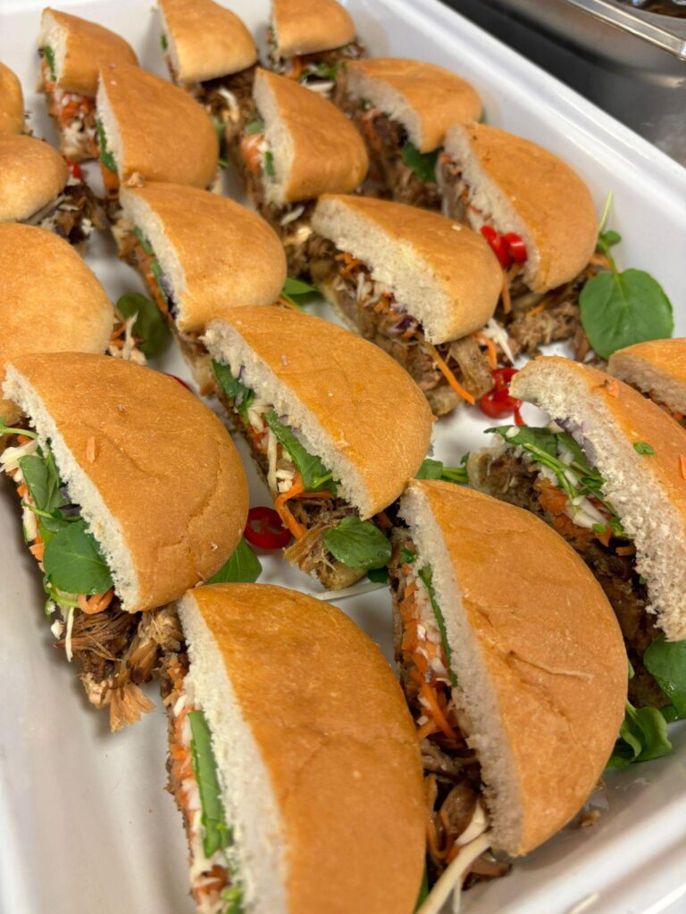 A tray of Asian style sandwiches including pulled pork, chilli and salad waiting to be served up at a hospitality venue