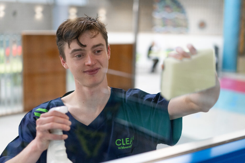 Mount Charles cleaning contracts team member cleaning glass pane