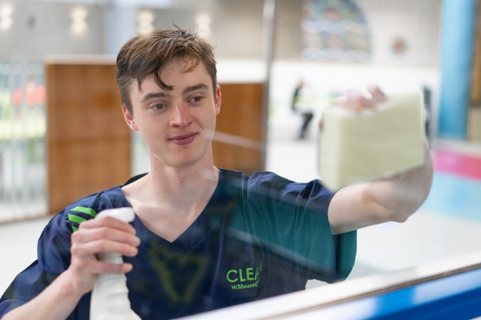 Mount Charles cleaning contracts team member cleaning glass