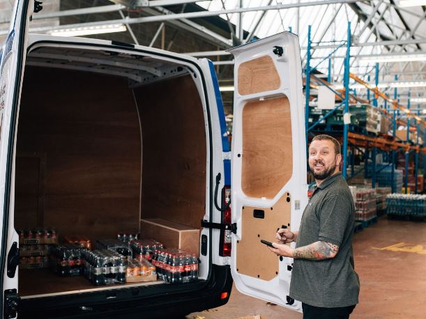 A vending team member unpacks his van in the warehouse