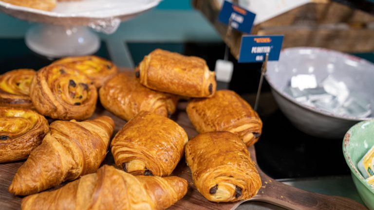 A selection of Pain au chocolat with the Kitchen branding in the background